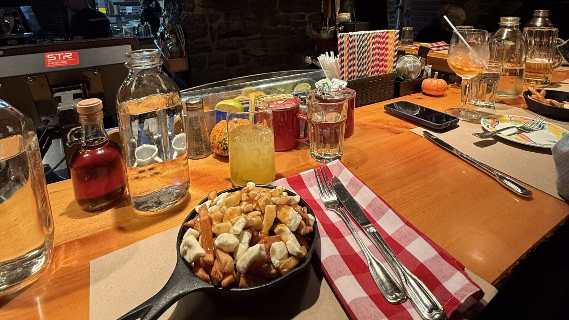 A table displaying a bowl of fries alongside a plate of golden, crispy French fries.