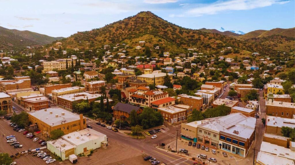 Aerial view of Colorado town showcasing buildings, streets, and surrounding landscape under a clear blue sky.