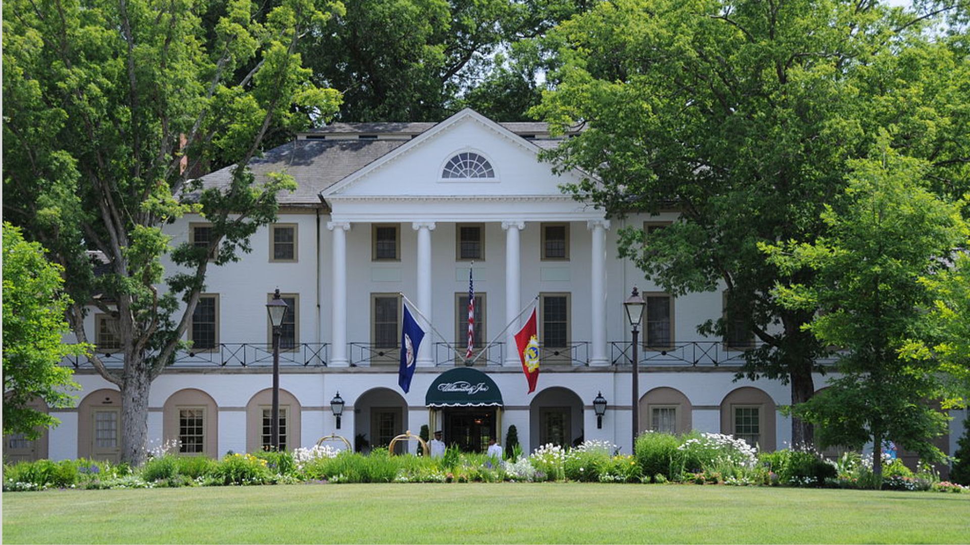 The White House set in a lush green field, showcasing its iconic architecture against nature.