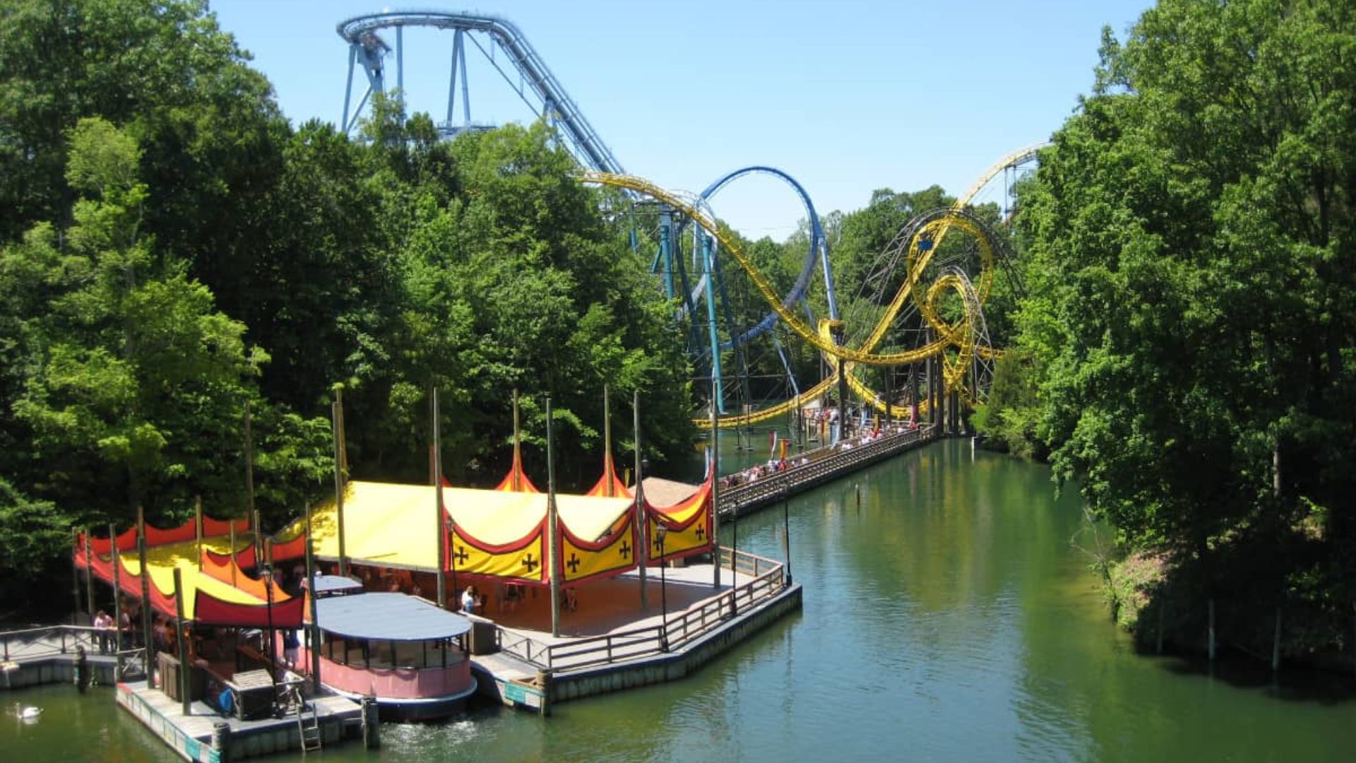 . A riverboat featuring a roller coaster and a vibrant water park, showcasing a fun-filled recreational environment.