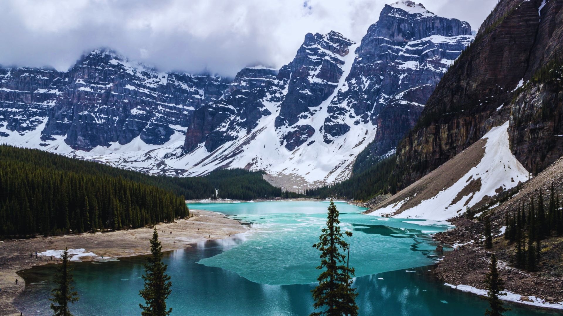 Moraine Lake in Banff National Park, Alberta, Canada, surrounded by towering mountains and lush pine forests.