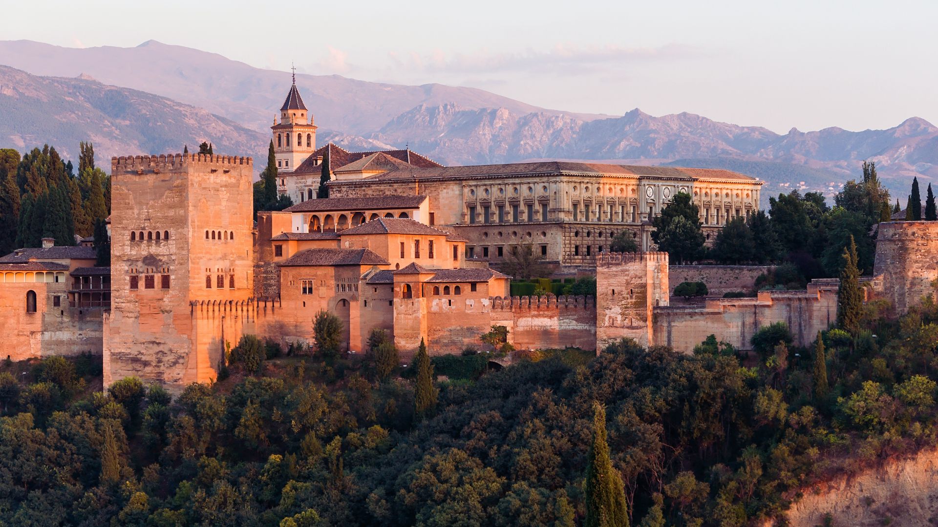 The Alhambra Palace in Granada, Spain, showcasing intricate Islamic architecture and lush gardens.