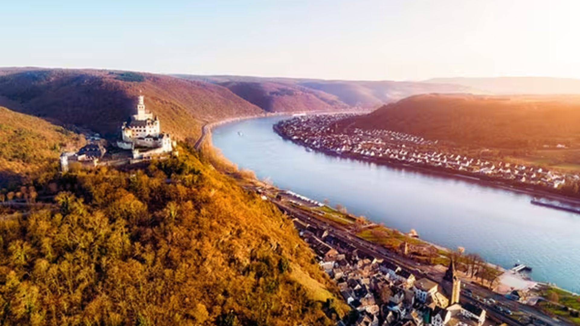 Aerial view of the Rhine River winding through the Rhine Valley, showcasing the historic Rhine Valley Castle in Germany.