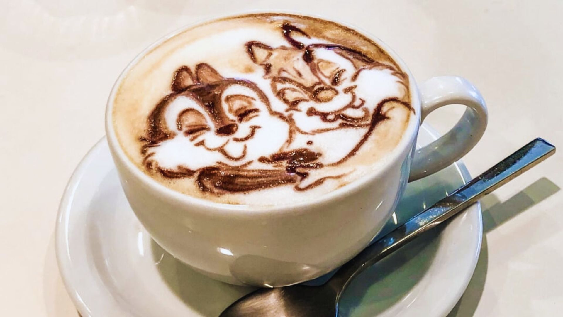 A coffee cup featuring a cartoon character design on its surface, adding a playful touch to the beverage.