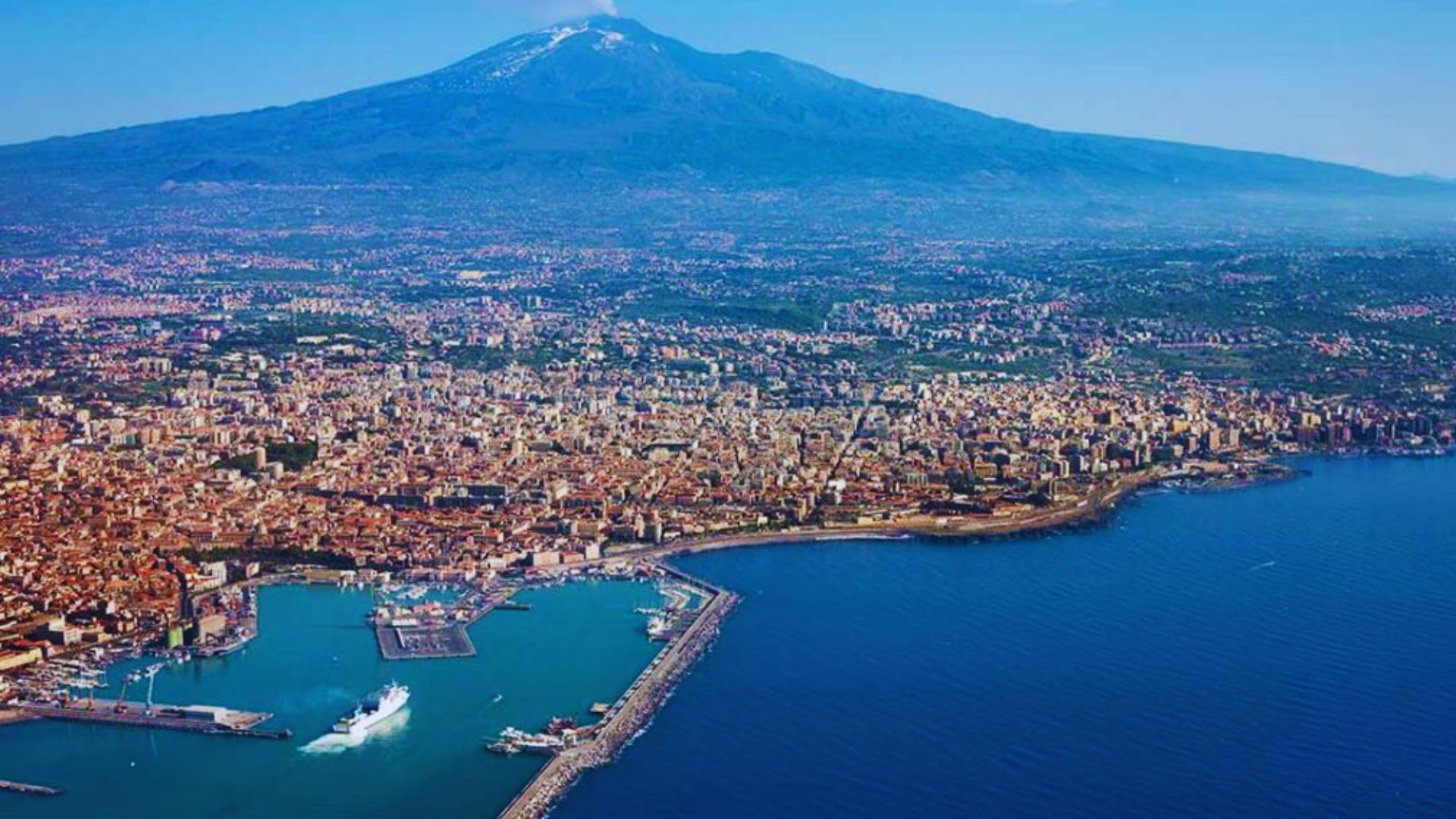 Aerial view of Naples, Italy, showcasing the city's coastline, historic buildings, and vibrant urban landscape.