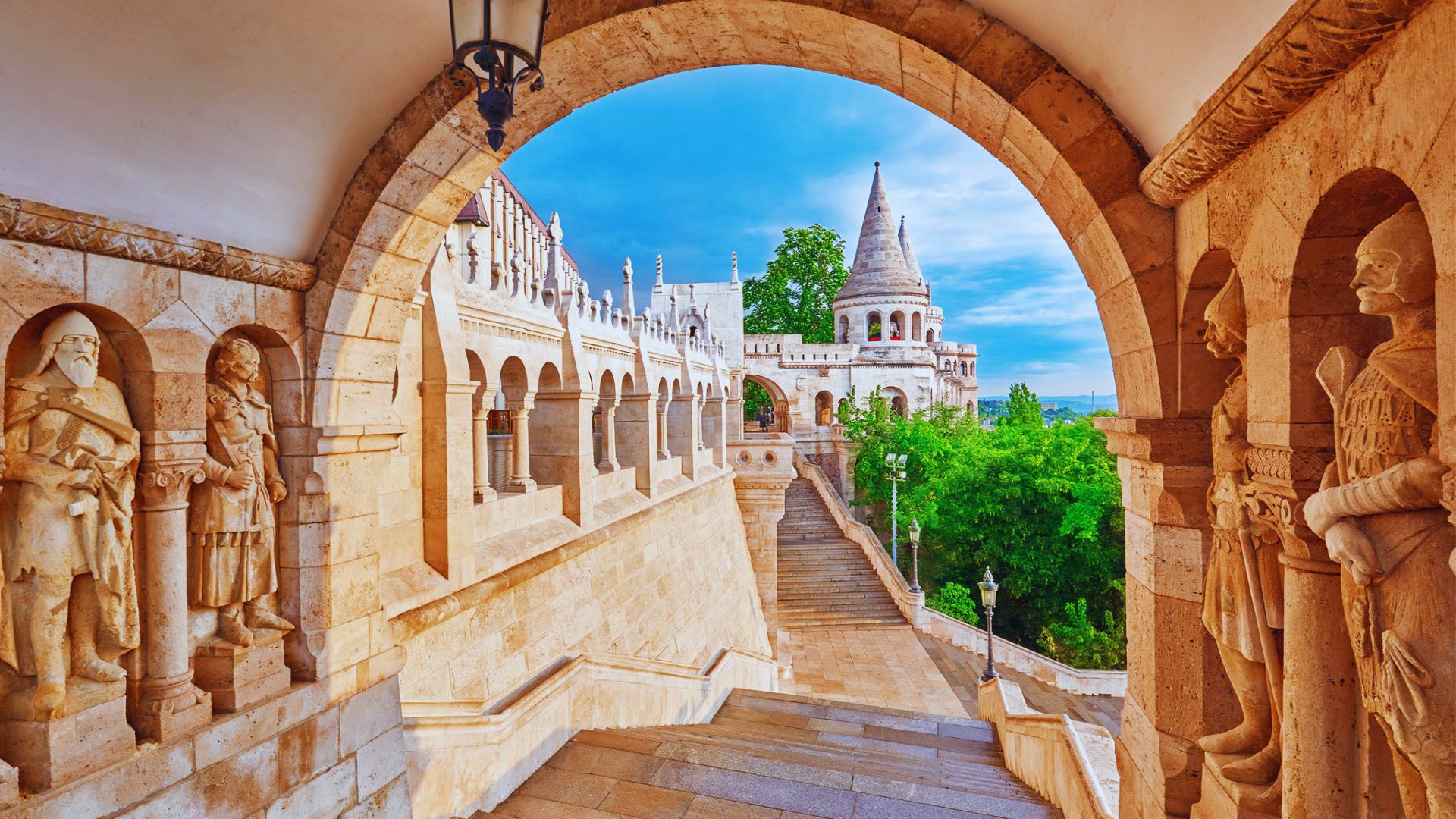 View from the top of the stairs at Budapest Castle, showcasing the city skyline and the Danube River below.