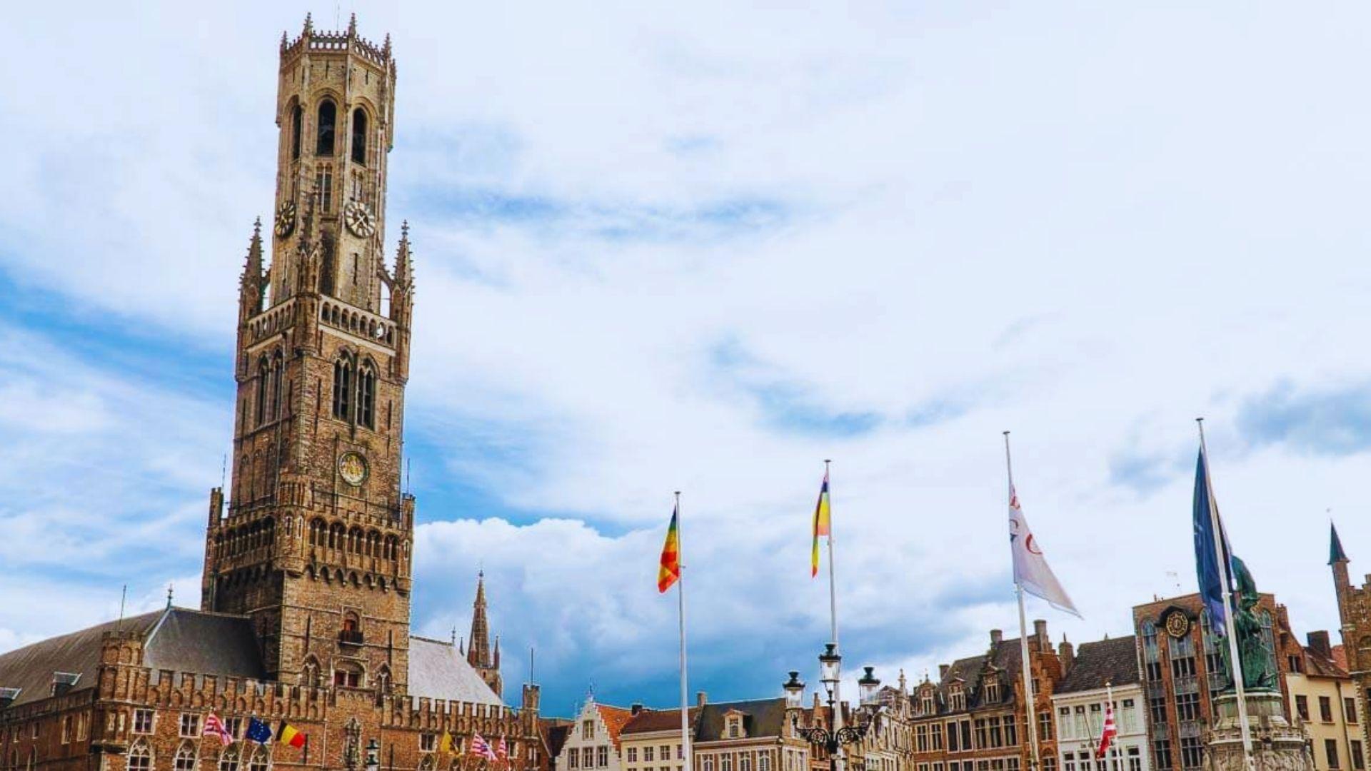 City Hall of Bruges, Belgium, showcasing Gothic architecture with intricate details and a prominent bell tower.