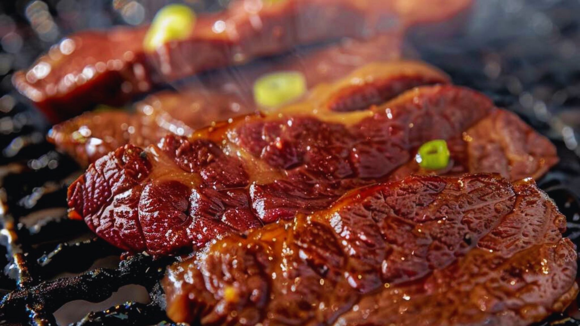 Grilled beef steak sizzling on the barbecue, showcasing a rich brown crust and juicy texture.