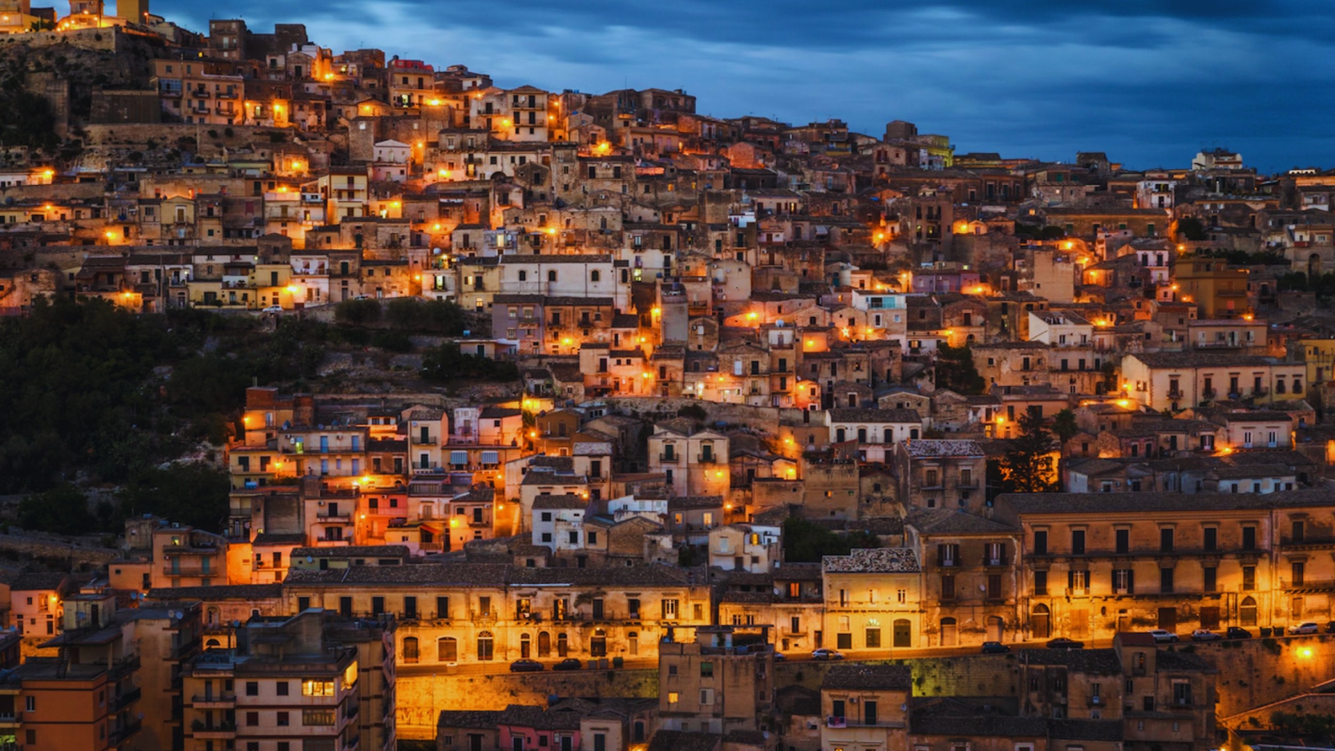 Amatrice, Italy, at dusk, showcasing a serene skyline with soft twilight hues illuminating the historic architecture.