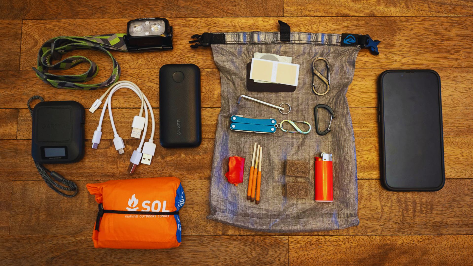 A bag of assorted items displayed on a table, showcasing various objects arranged neatly.