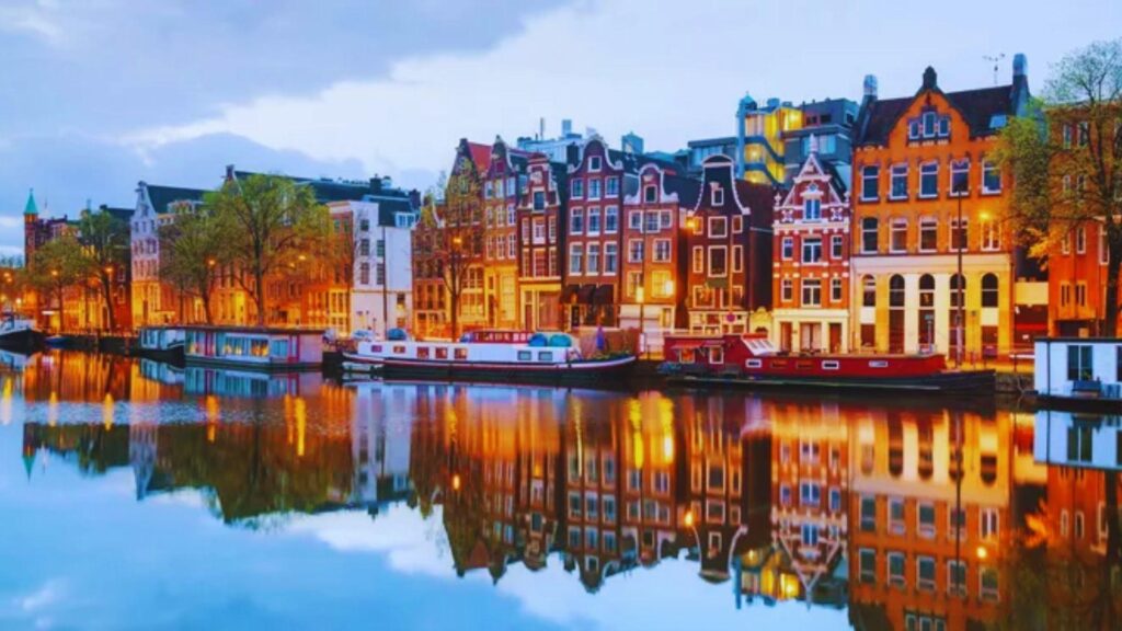Scenic view of Amsterdam's canals and historic buildings, showcasing the charm of European travel.