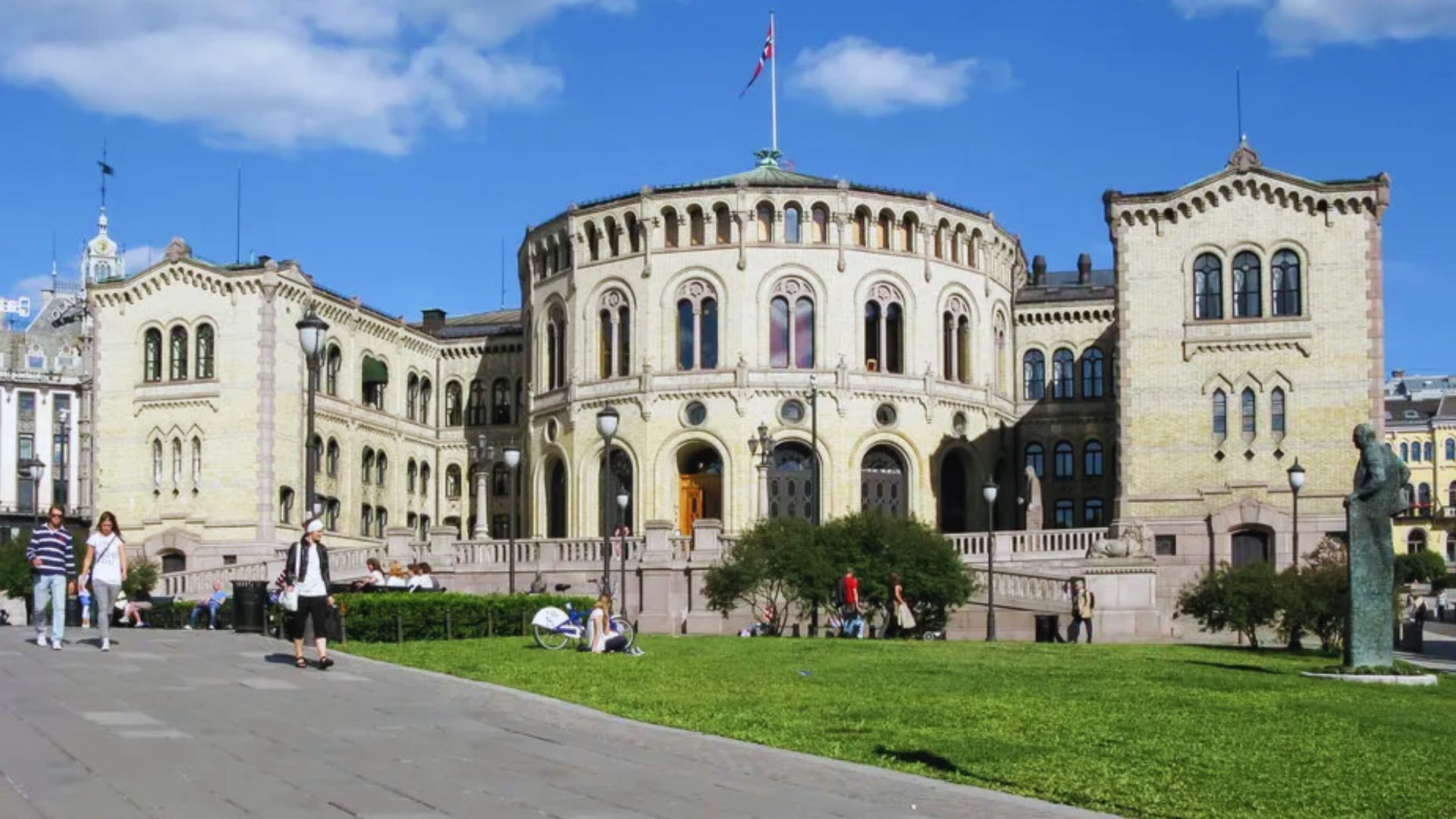 The parliament building in Oslo, Norway, showcasing its distinctive architecture and surrounding greenery.