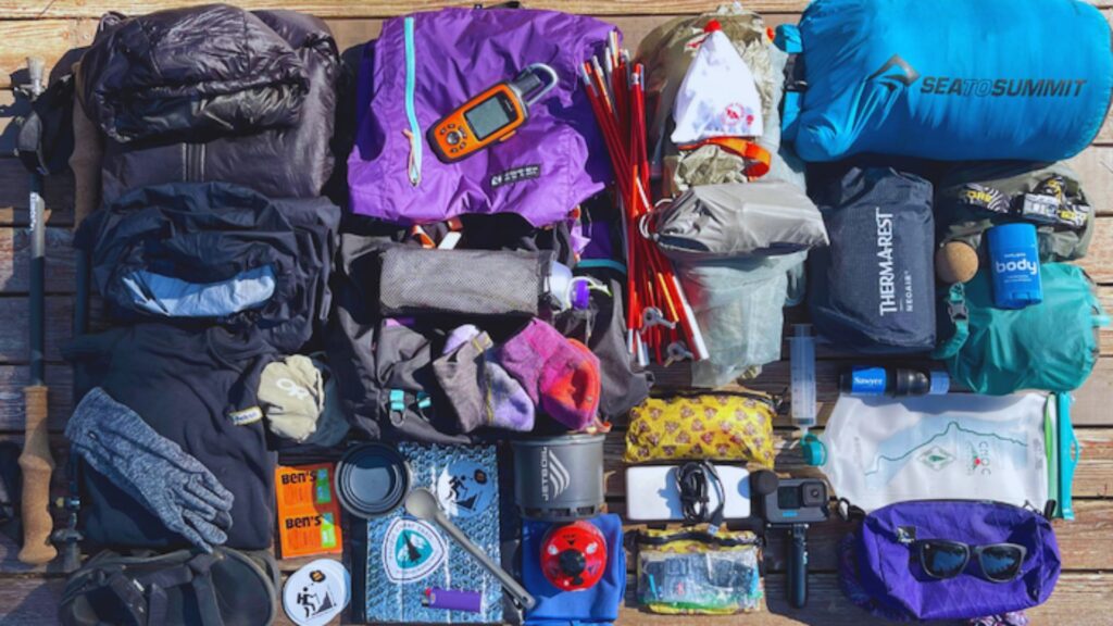 A variety of colorful items arranged neatly on a wooden floor, showcasing different shapes and sizes.