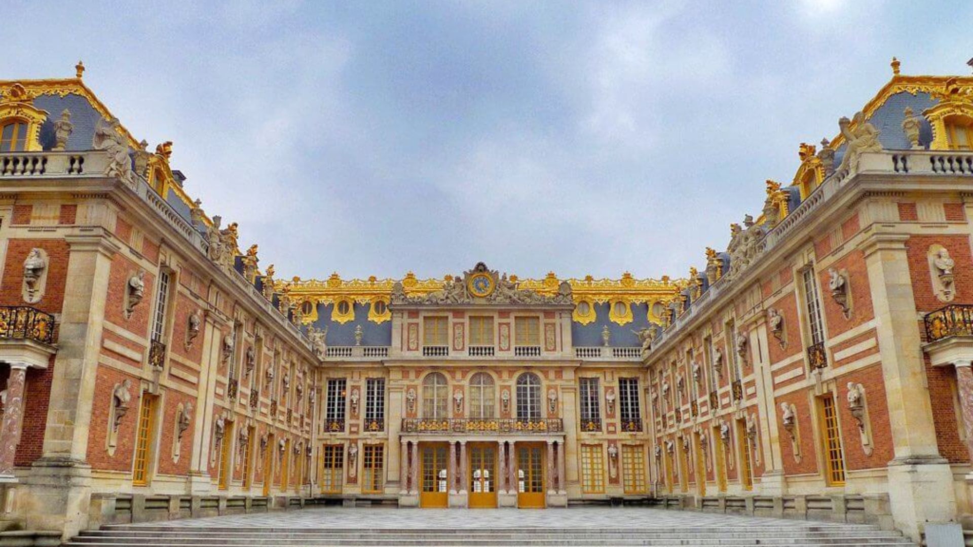 The Palace of Versailles, a grand historic building with ornate architecture and expansive gardens, symbolizing French royalty.