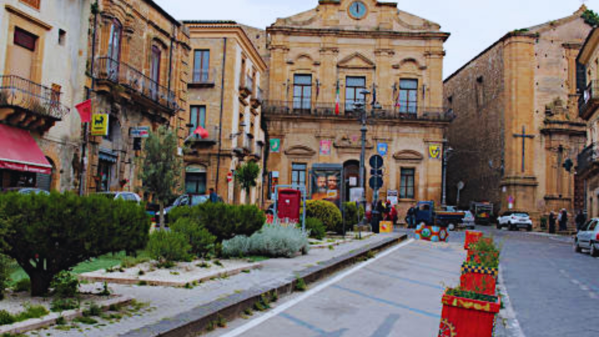 A street scene featuring a building in the background, showcasing urban architecture and a clear sky.