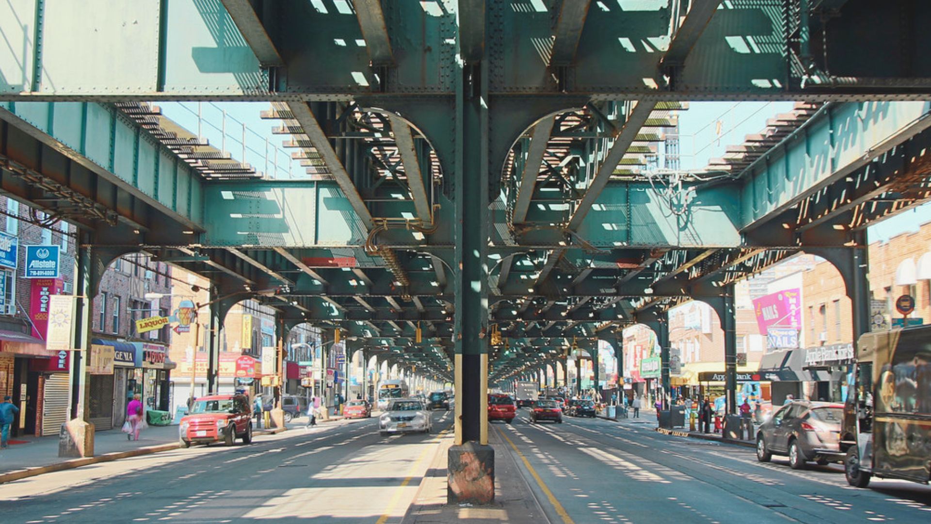 A busy street scene featuring cars and pedestrians interacting in an urban environment.