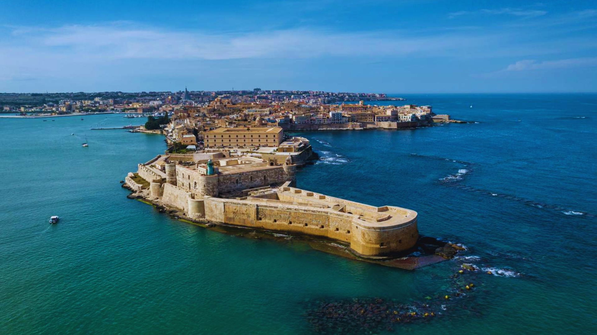 Aerial view of Valletta, Malta, showcasing the historic city and the surrounding blue sea.