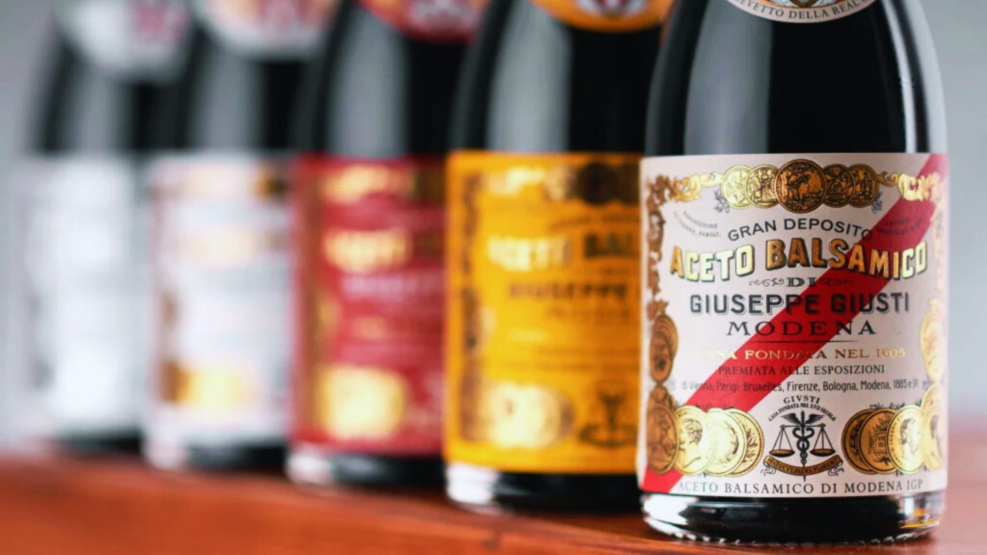 A row of various beer bottles, each featuring distinct and colorful labels showcasing different brands and styles.