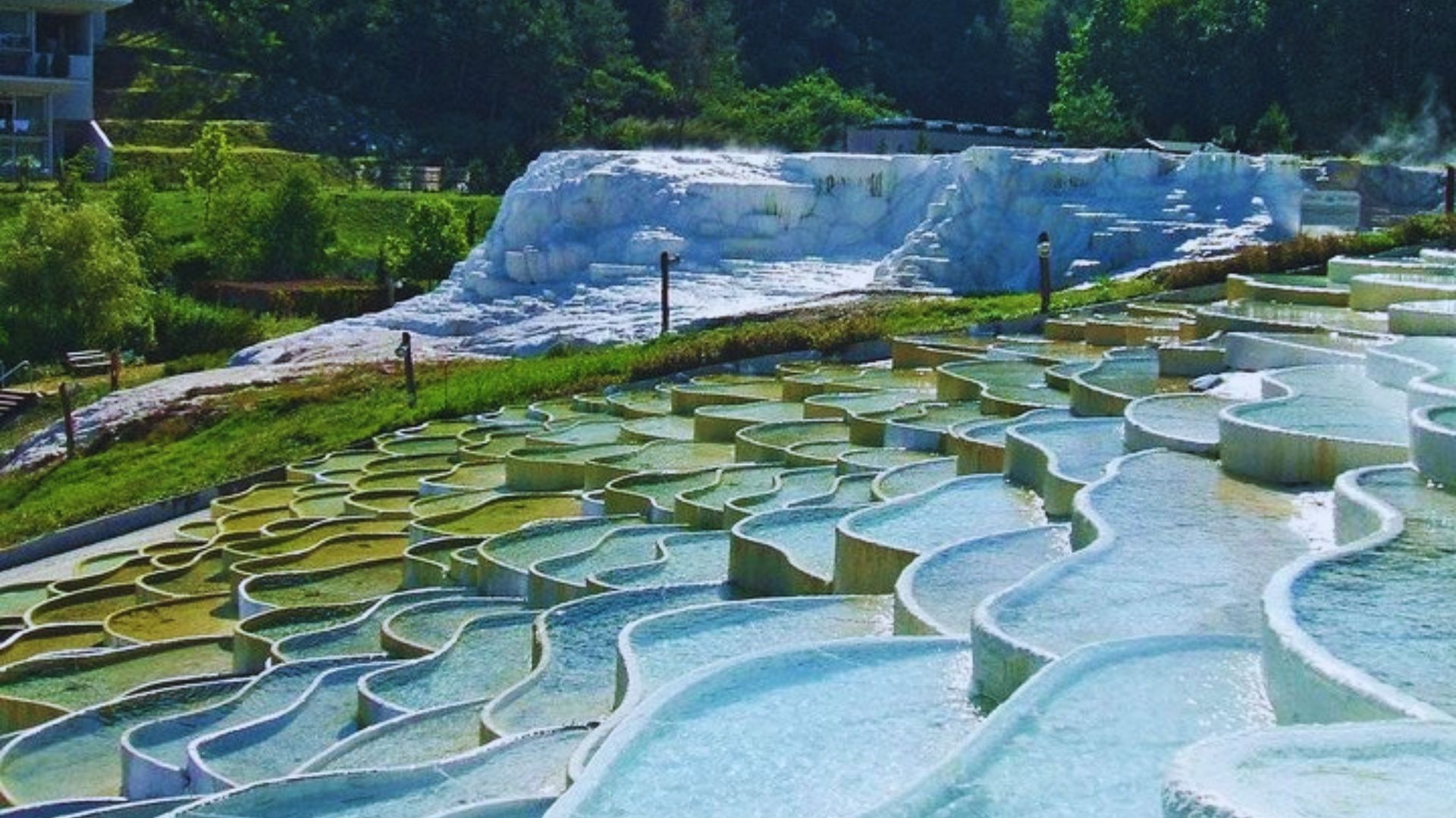 Serene Japanese hot springs surrounded by lush greenery and misty mountains, showcasing natural beauty and tranquility.