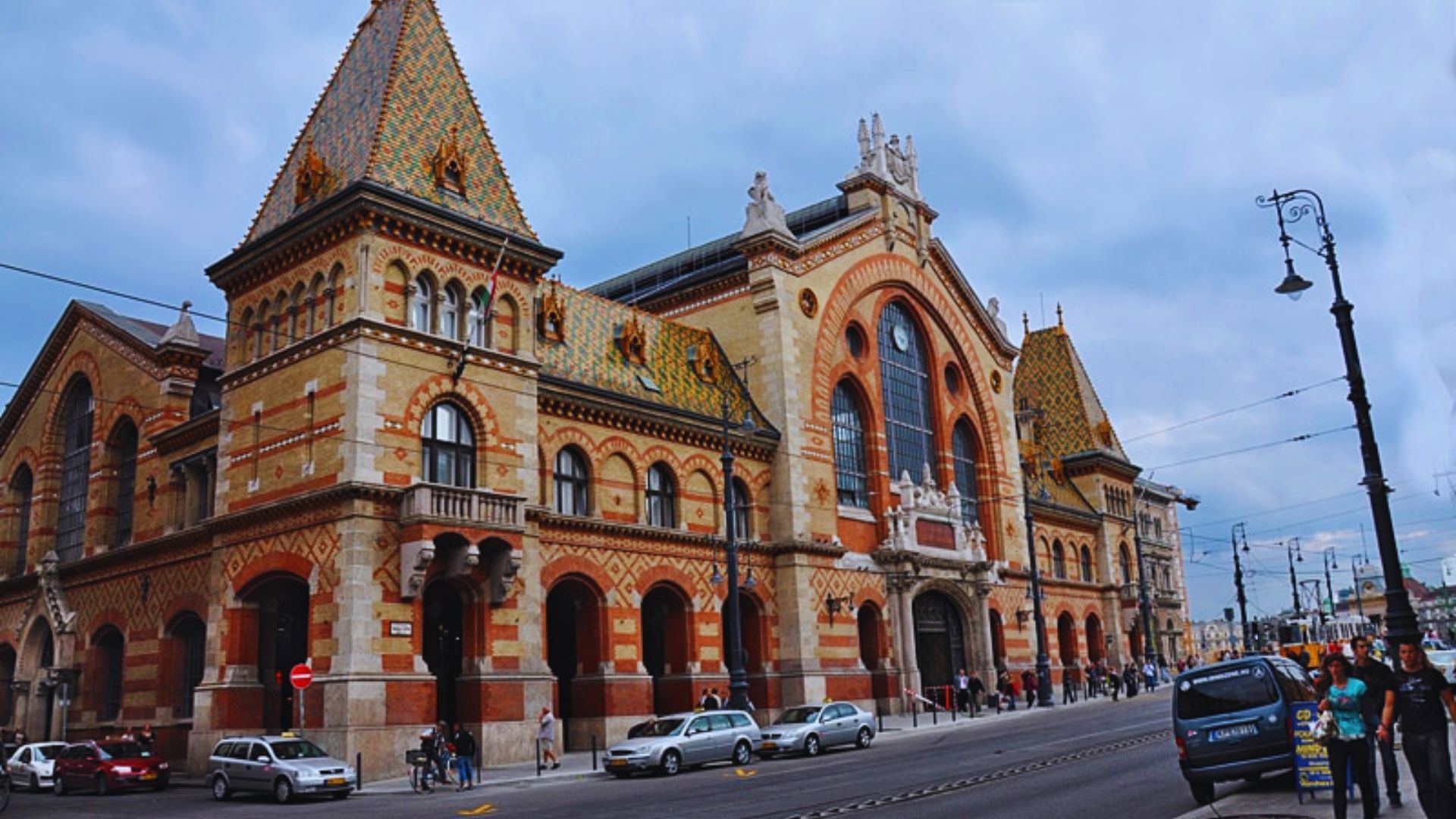 A large building featuring a prominent clock tower on its side, showcasing architectural details and grandeur.