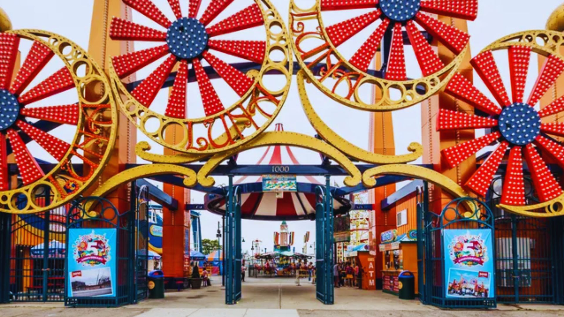 A vibrant carnival entrance featuring colorful wheels and festive decorations, inviting visitors to enjoy the festivities.