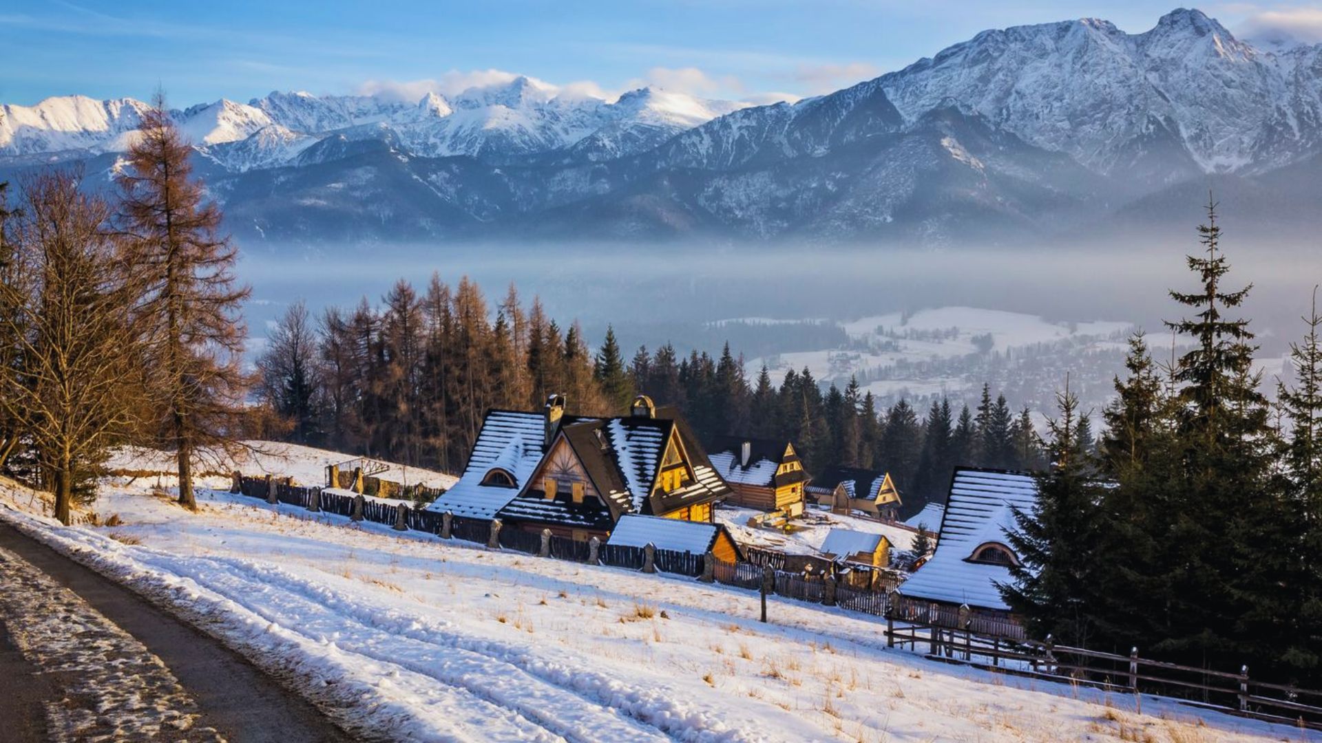 A picturesque snowy mountain village surrounded by snow-covered trees in a serene winter landscape.