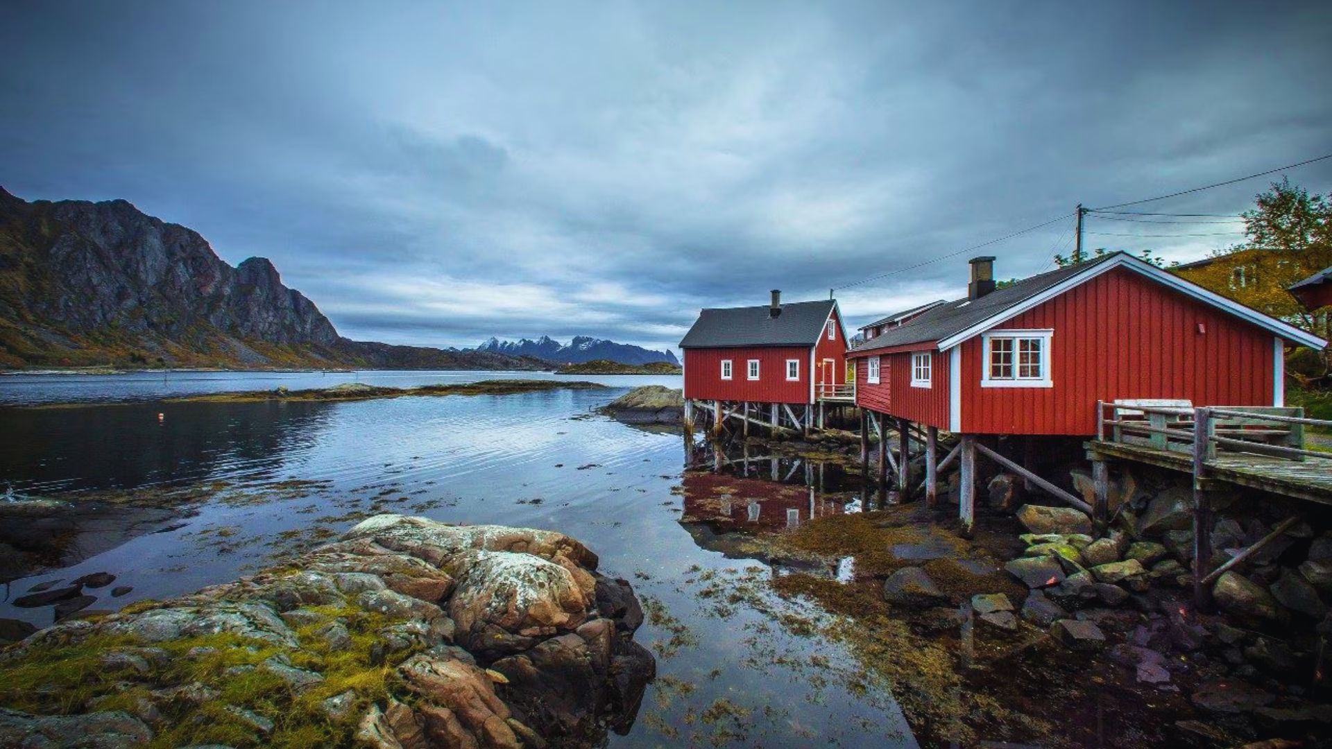 Image of a red house captured by James Kennedy, highlighting its striking hue and charming architectural details.