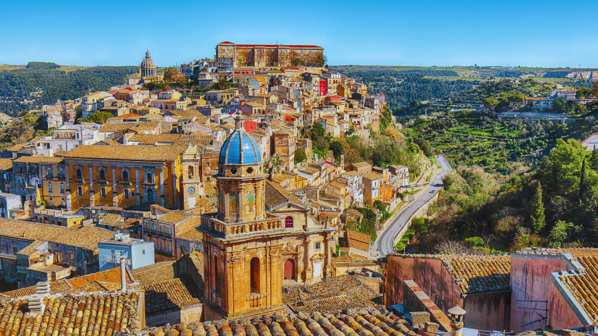 A panoramic view of Amatrice, Italy, showcasing its historic architecture and surrounding mountainous landscape.