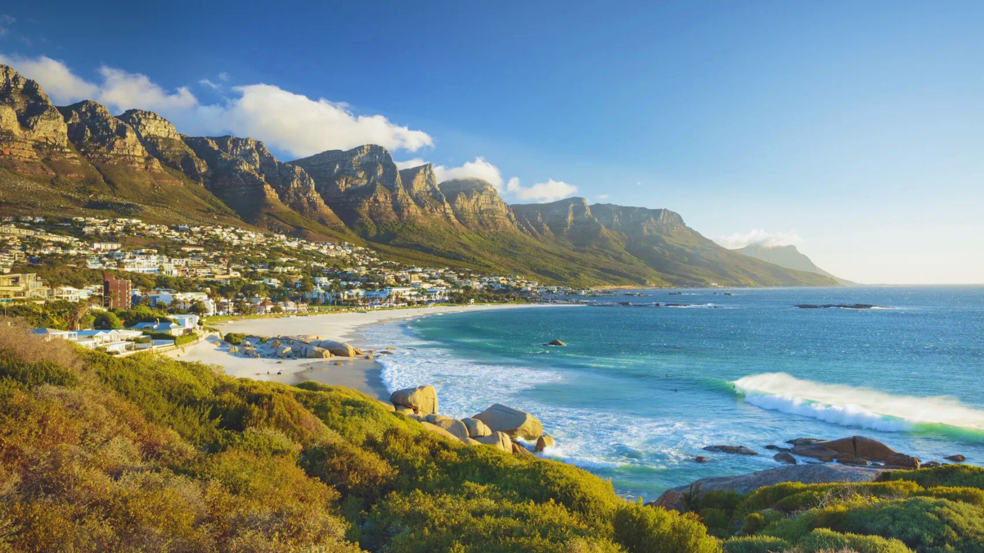 Scenic landscape of Cape Town, South Africa, featuring Table Mountain and the bustling urban environment below.