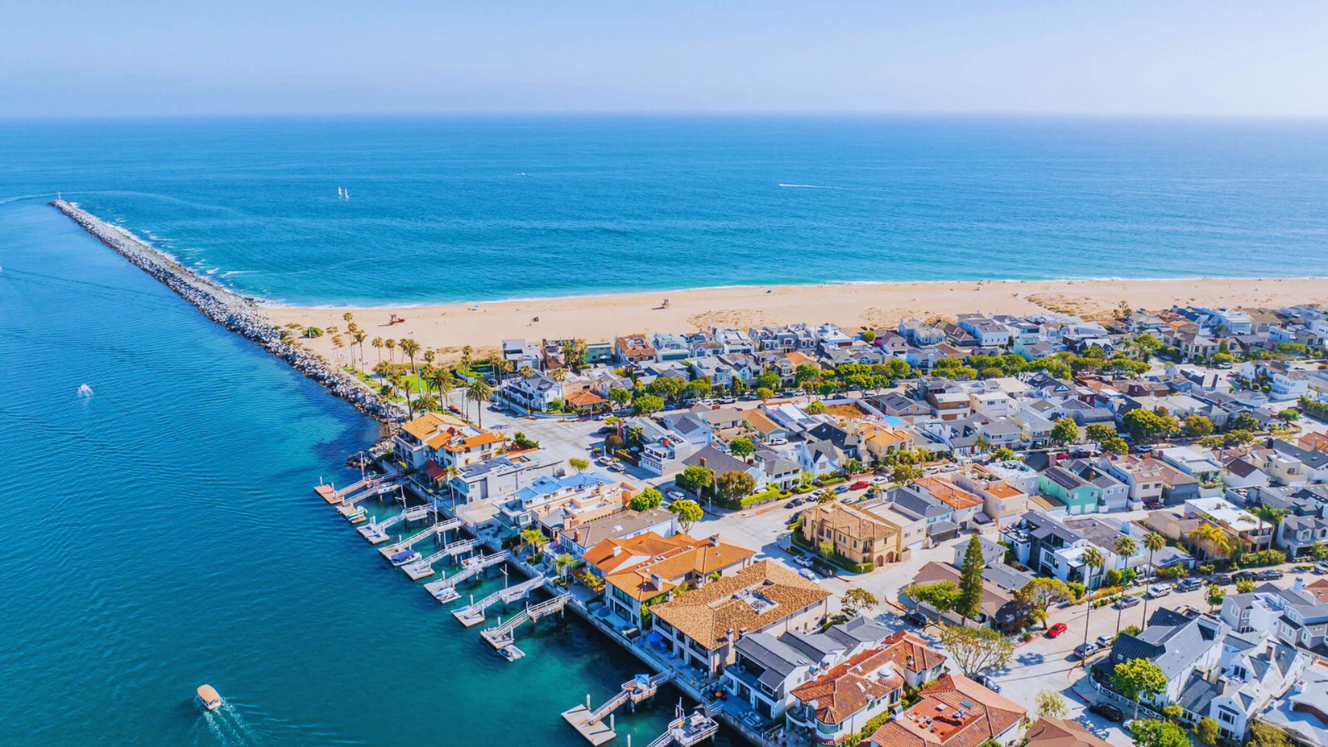 Overhead perspective of Malibu's coastline, featuring a sandy beach meeting the vibrant blue waters of the ocean.