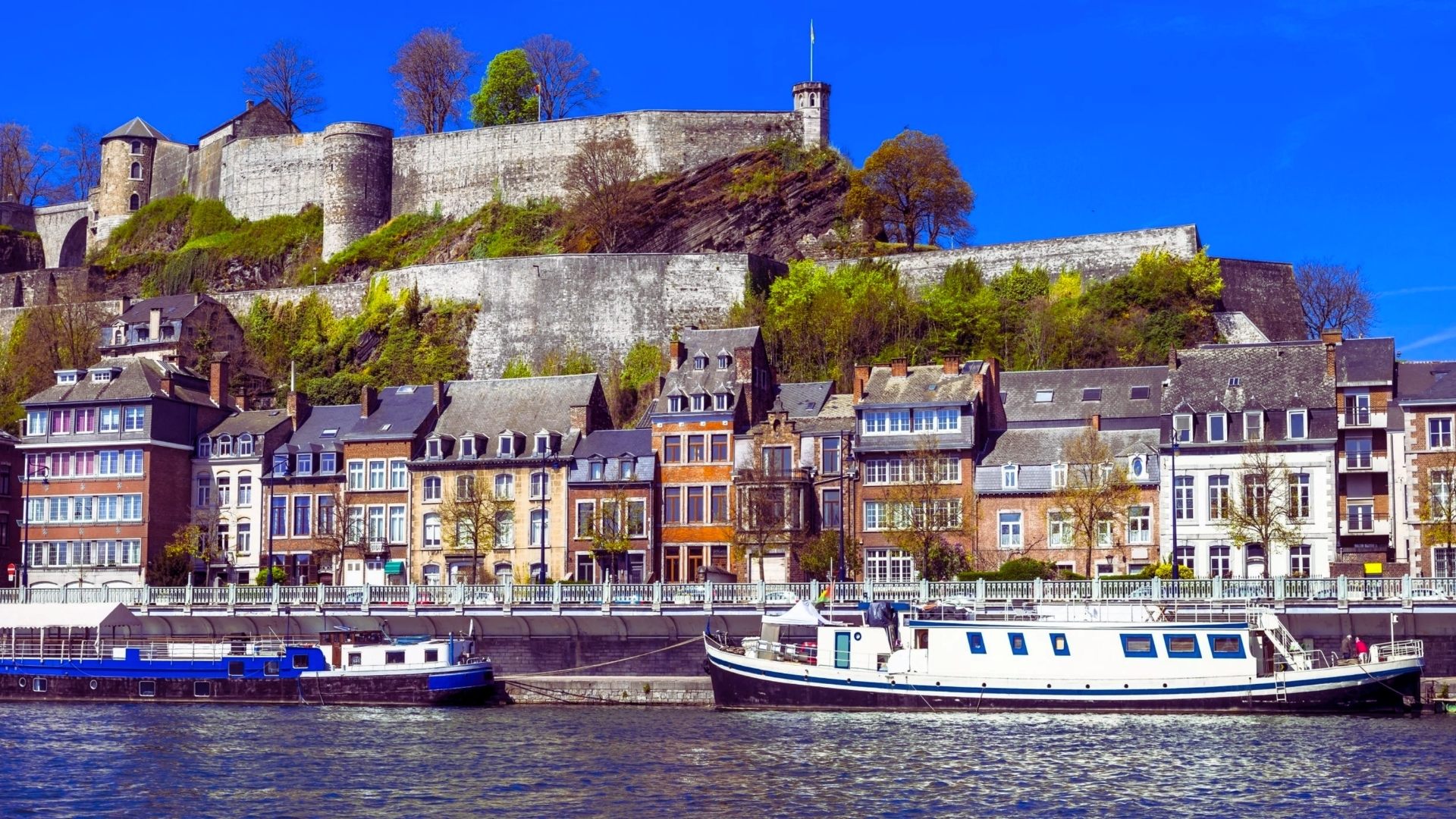 A scenic image of Lyon, France, highlighting its blend of modern and historic buildings against a clear blue sky.