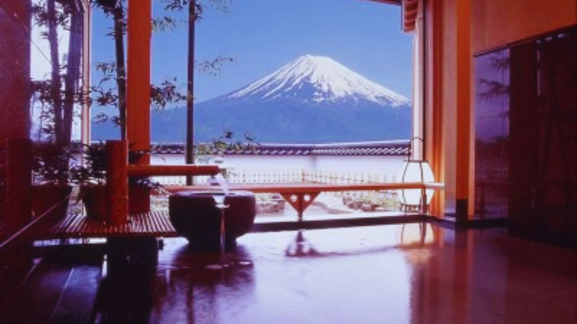 A serene bathroom featuring a large window with a stunning view of Mount Fuji in the background.