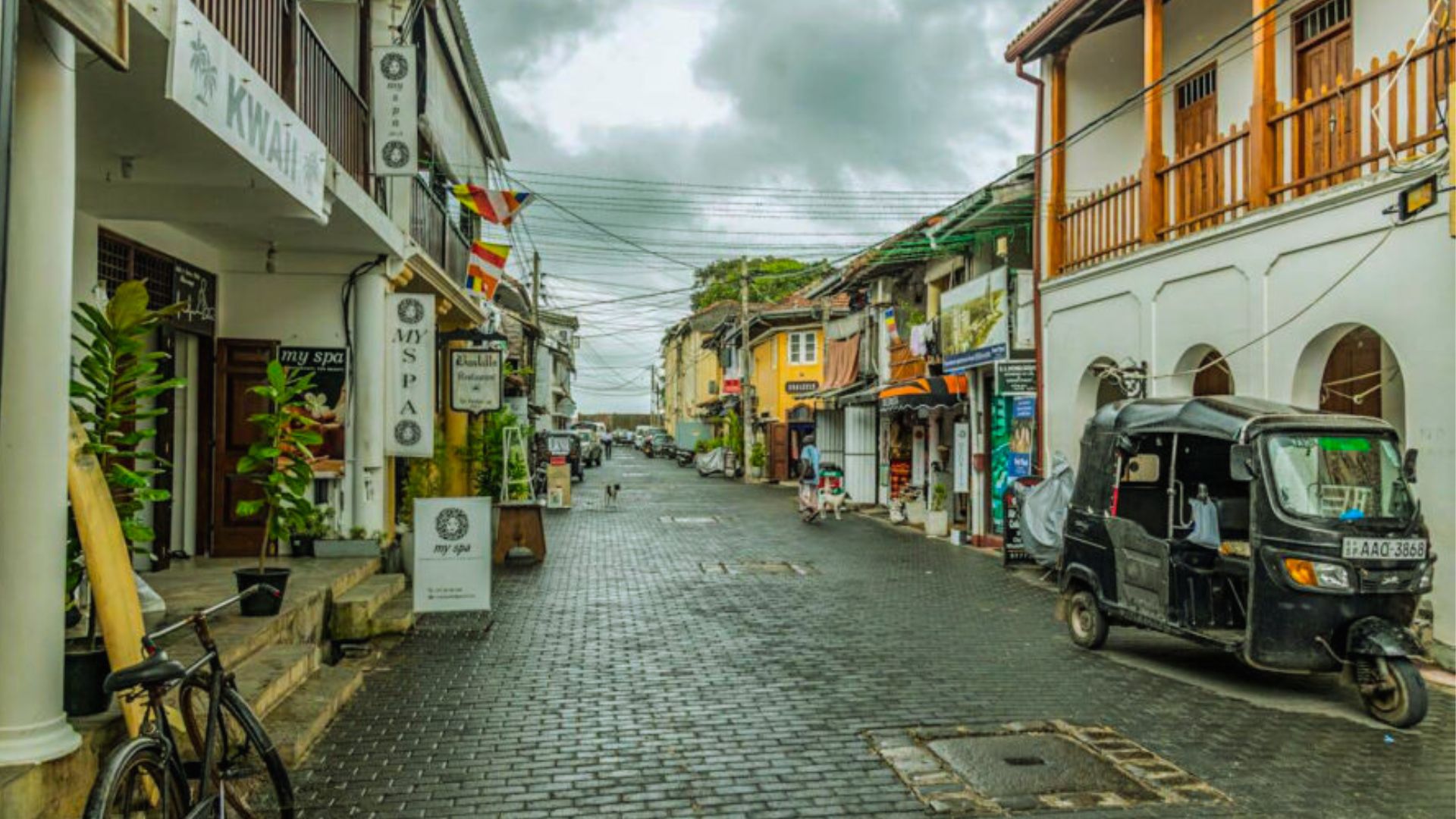A narrow street in the old town of Sri Lanka, lined with traditional buildings and vibrant local shops.