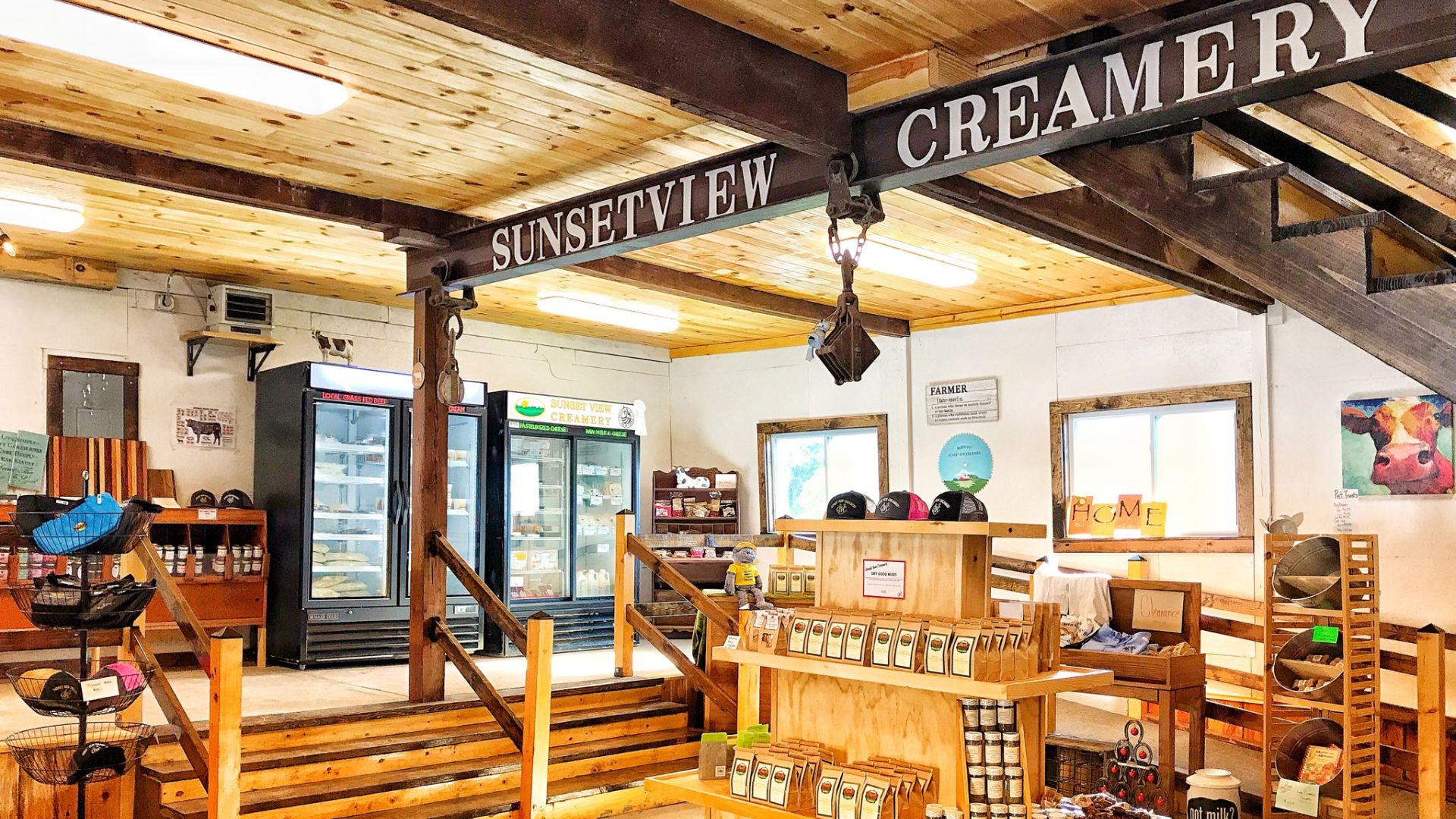 . A store interior featuring wooden floors and shelves filled with various products.