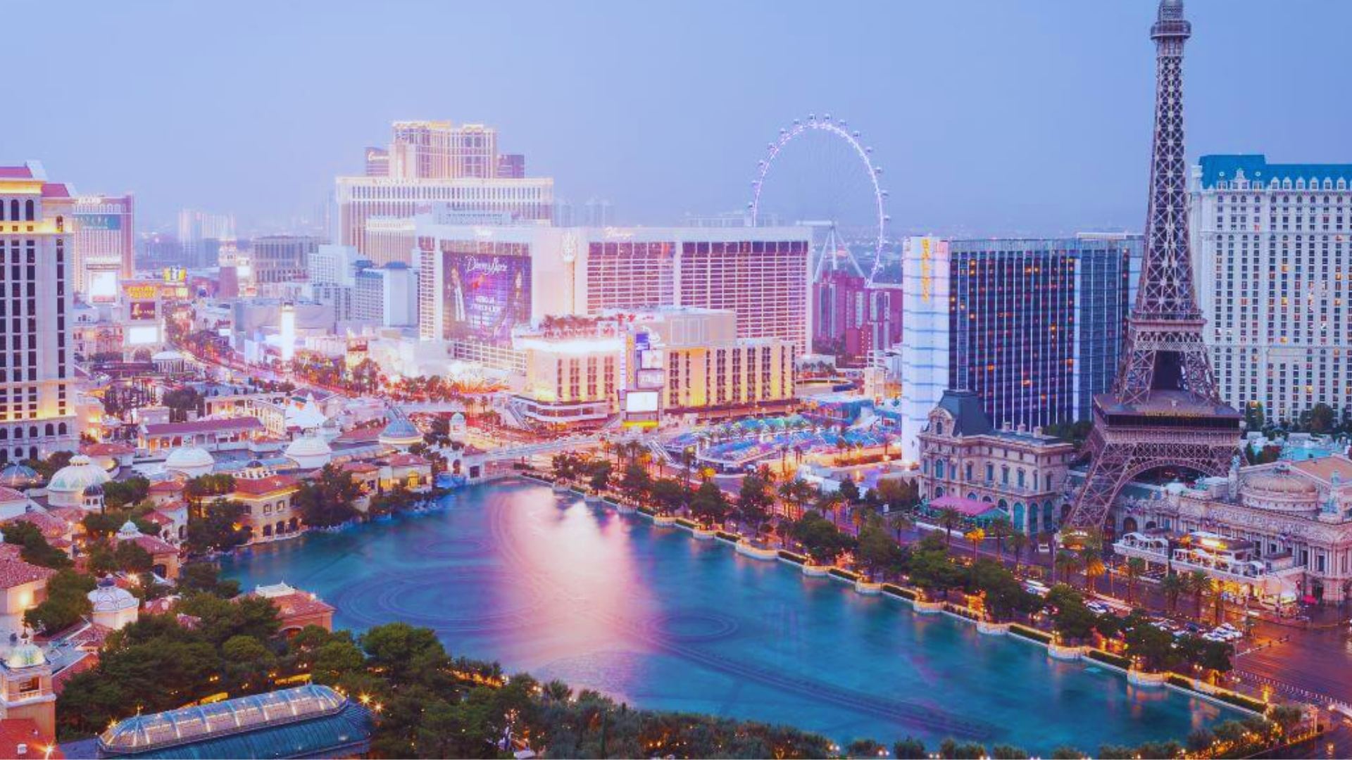 The Las Vegas Strip illuminated at dusk, showcasing vibrant lights and bustling activity along the famous boulevard.