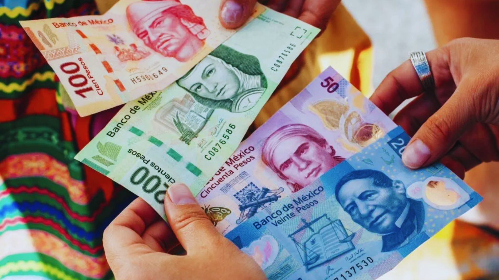A group of people joyfully holding up cash in their hands, showcasing their excitement and financial success.