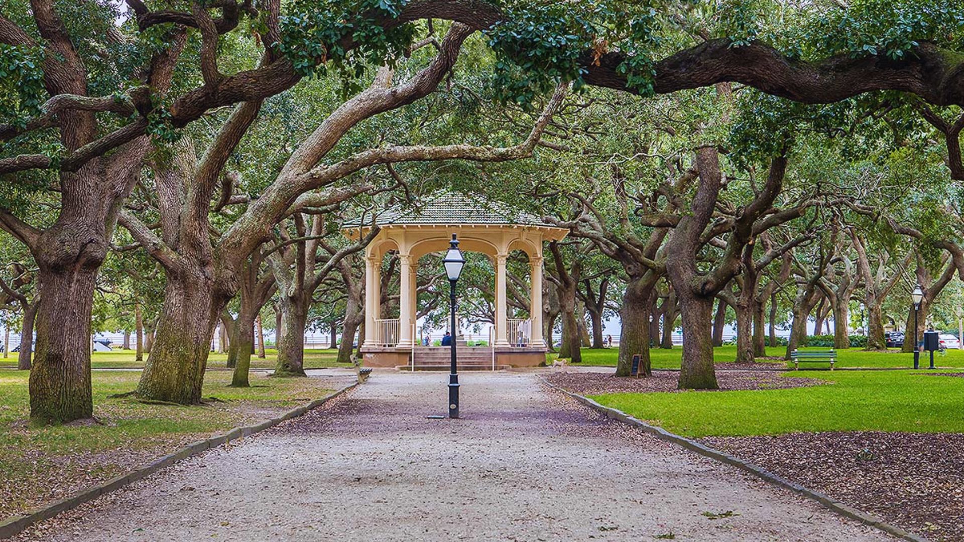 A gazebo nestled among lush trees in a serene park setting, inviting relaxation and enjoyment of nature.