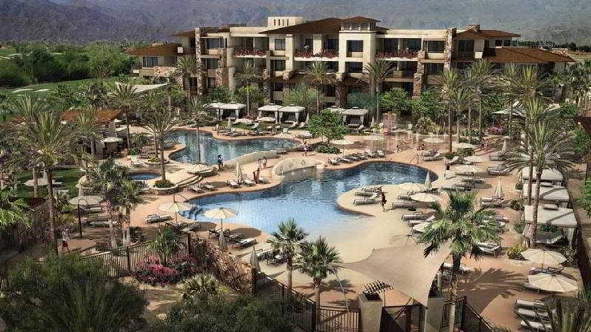 A scenic view of the Palm Springs resort, showcasing palm trees, a pool, and modern architecture under a clear blue sky.