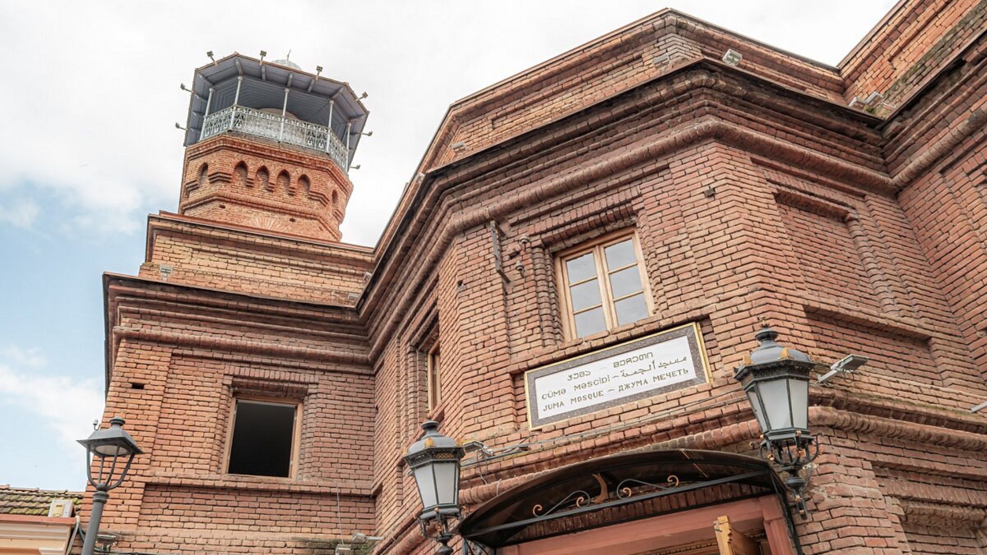 A historic building with a distinctive clock tower, showcasing architectural details.