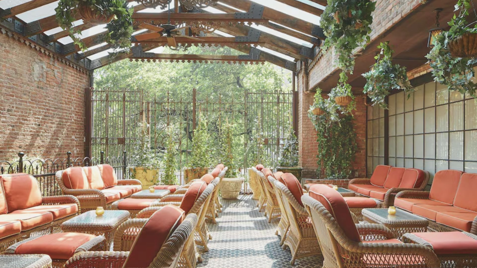 Rooftop patio at Hotel Barcelona featuring lounge seating and city views under a clear blue sky.
