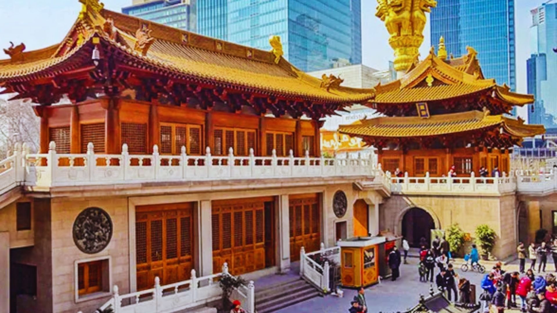 A large building featuring a prominent golden statue positioned at its center, showcasing architectural grandeur.