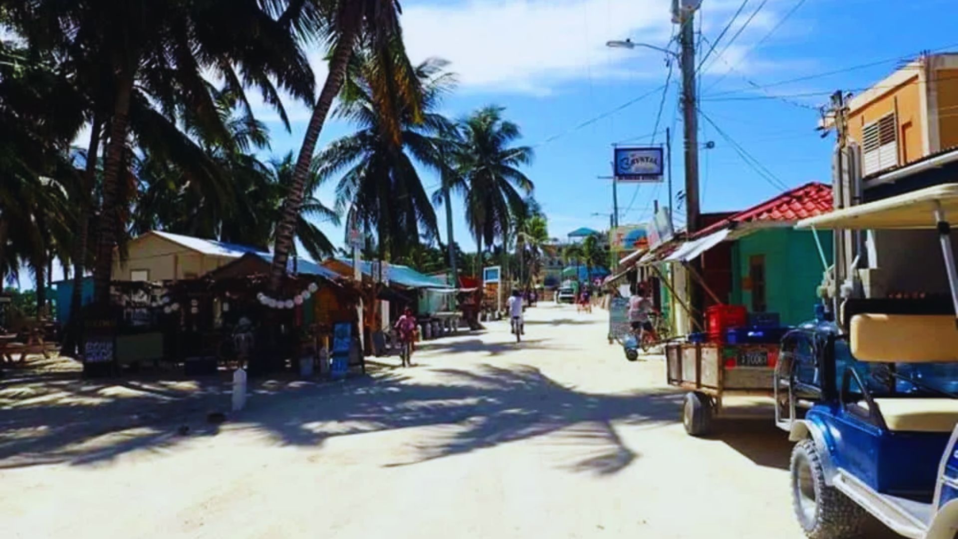 A quaint small town featuring a market and a small cart parked nearby, showcasing a peaceful community atmosphere.