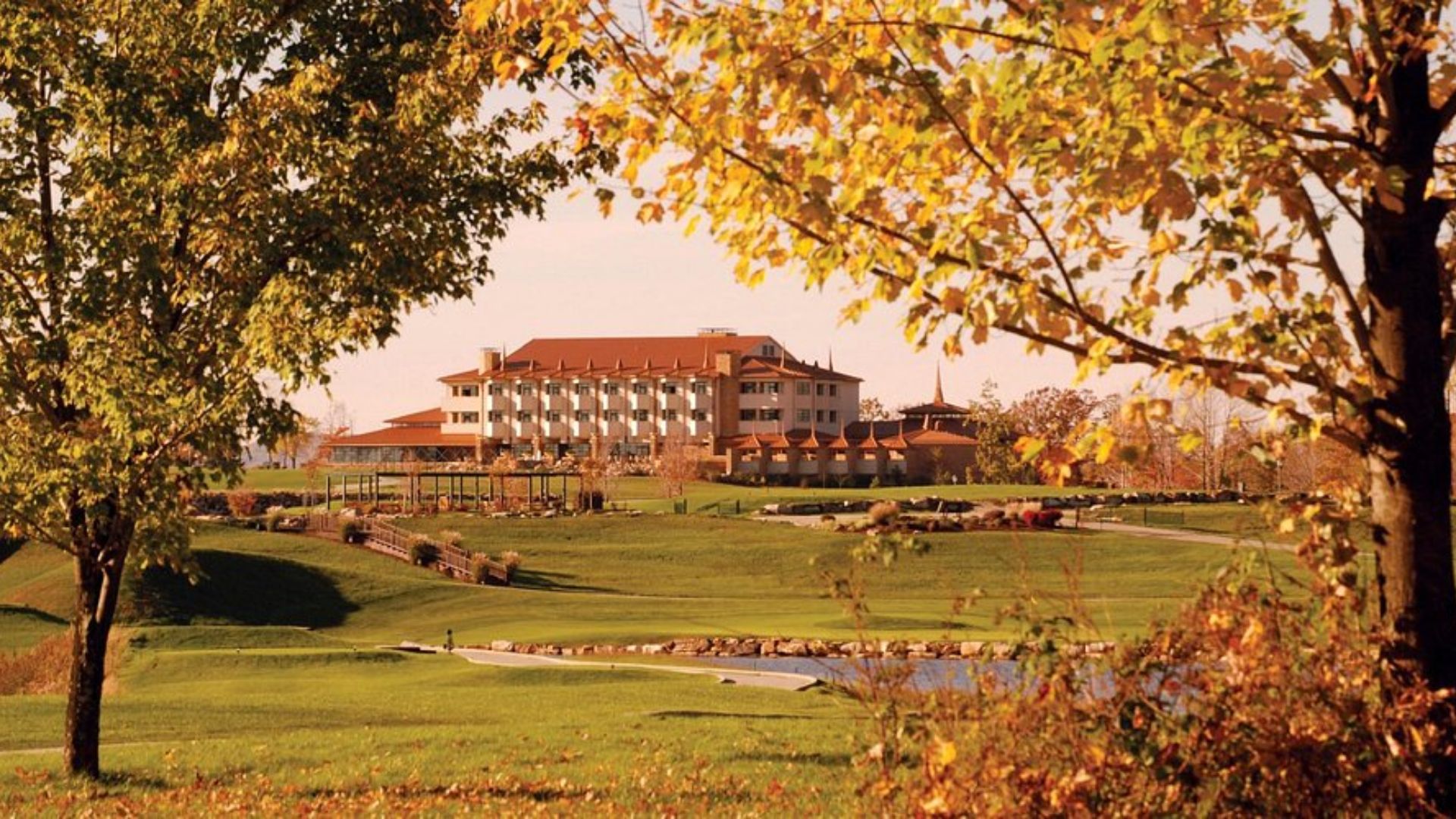 Scenic view of the golf course at the Inn at the Lake, featuring lush greens and a serene lakeside backdrop.