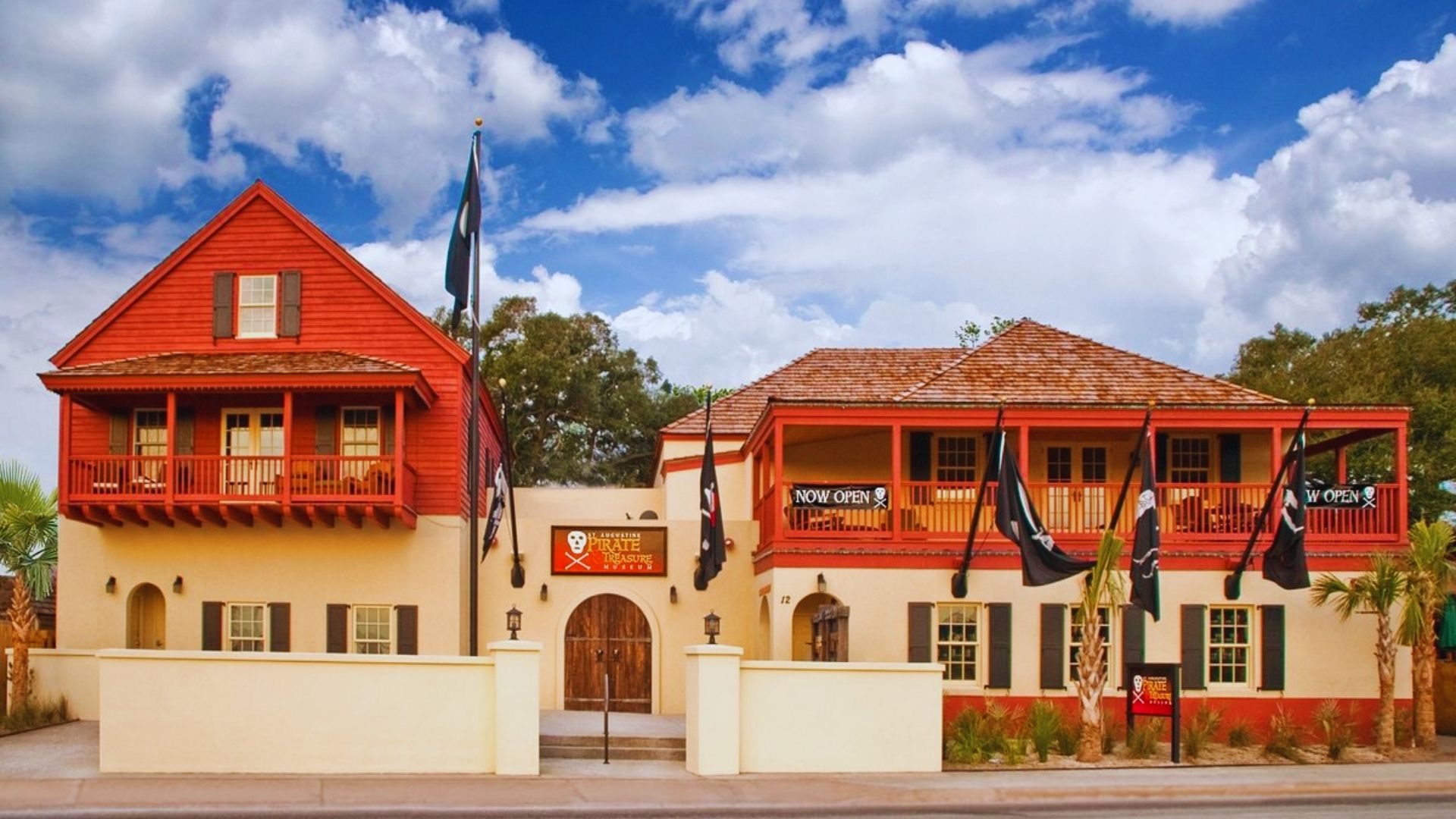 Two-story red and white building with a distinct architectural design.