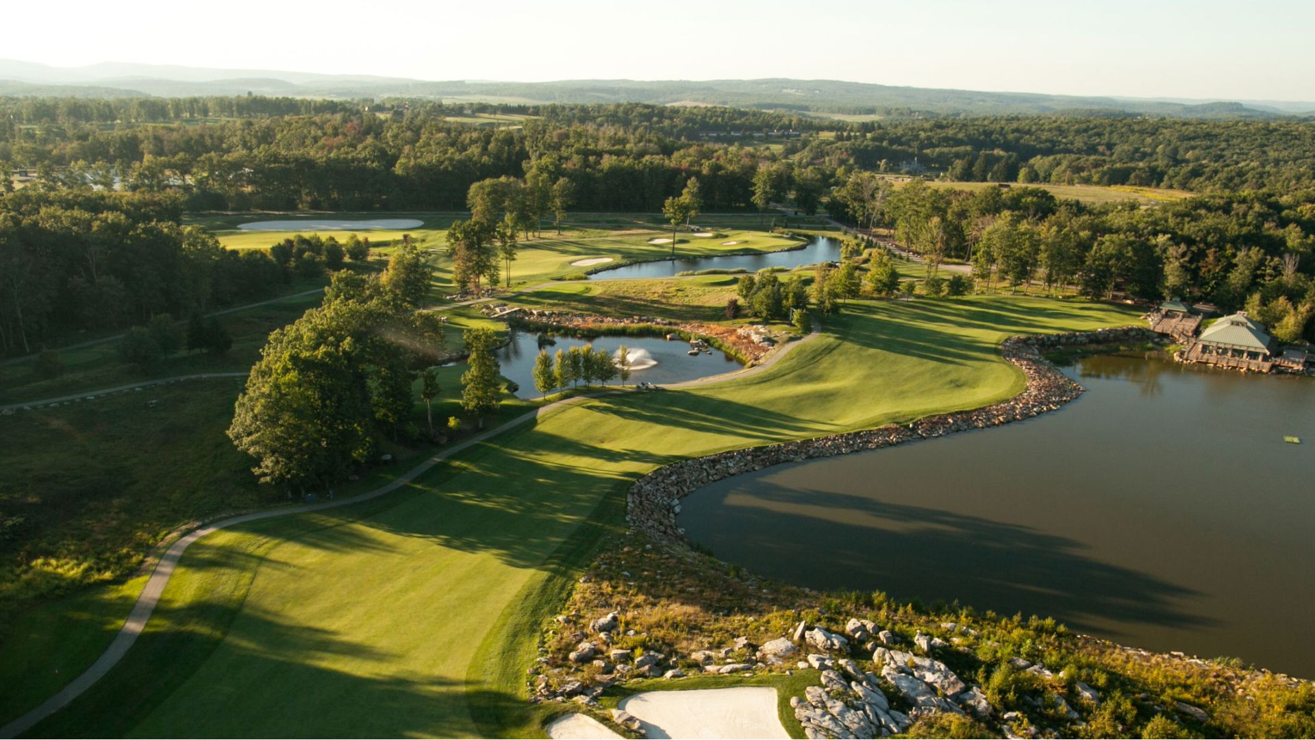A scenic view of the resort's golf course, surrounded by tranquil water on all sides.