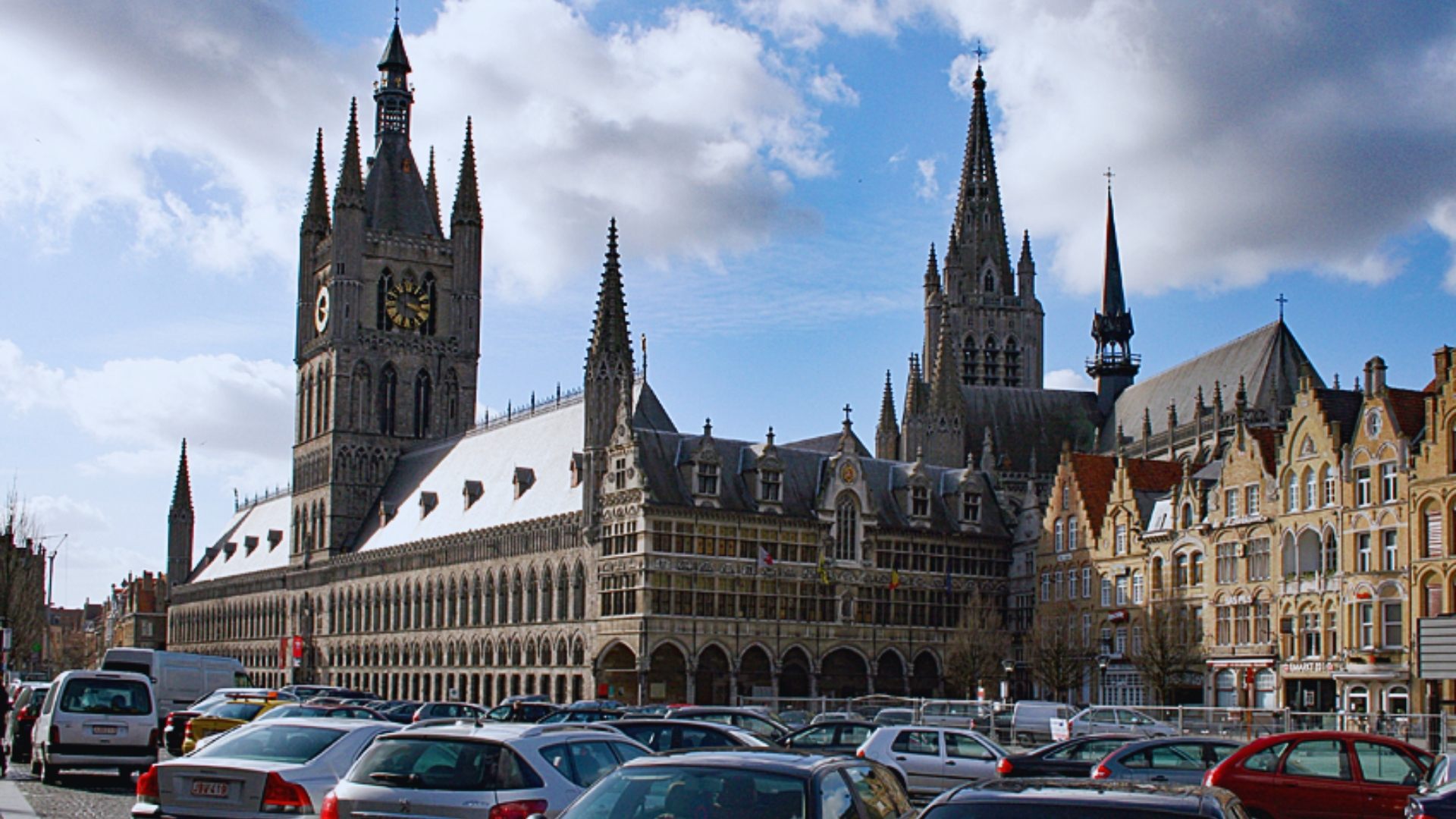 A large building featuring a prominent clock tower against a clear sky.