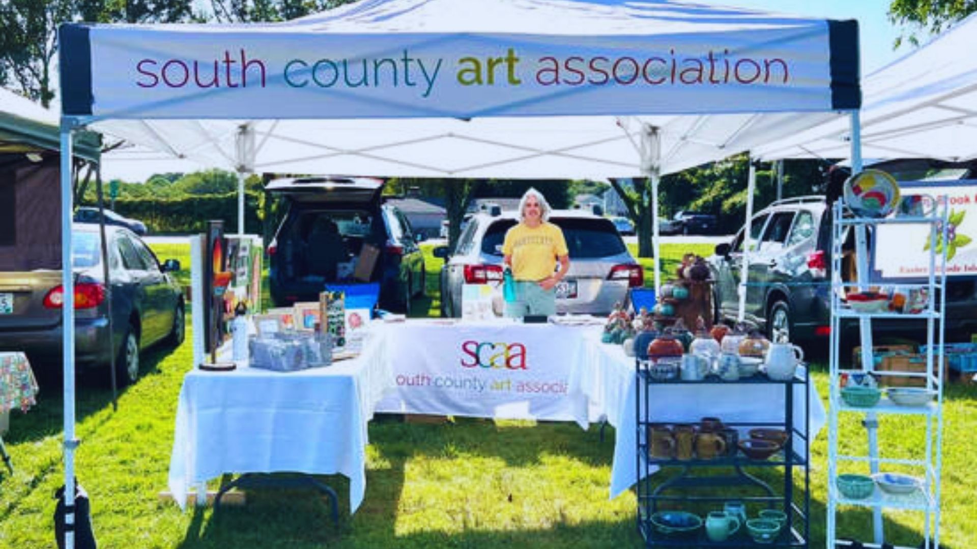 Logo of the South County Art Association featuring artistic elements and vibrant colors, representing local art initiatives.