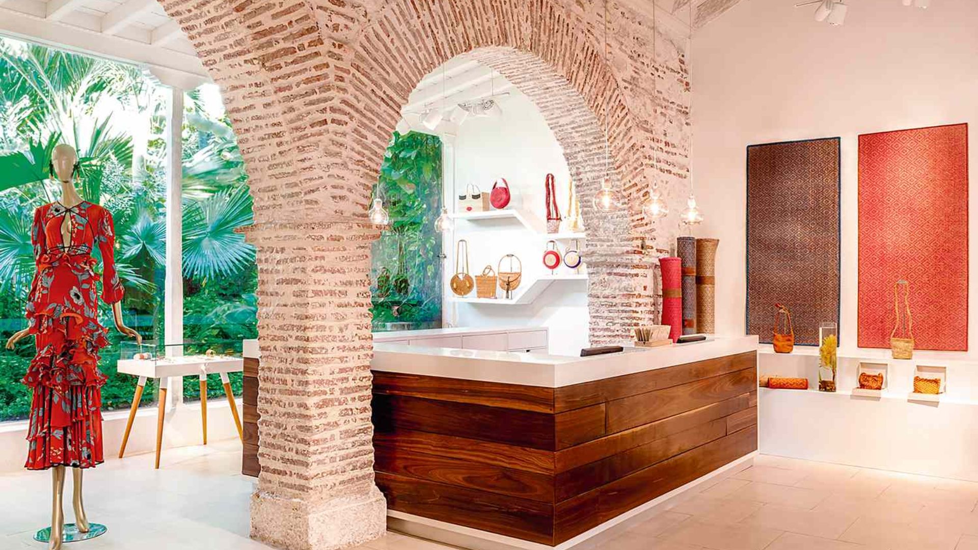 A room featuring a white counter and a red dress elegantly displayed on the wall.