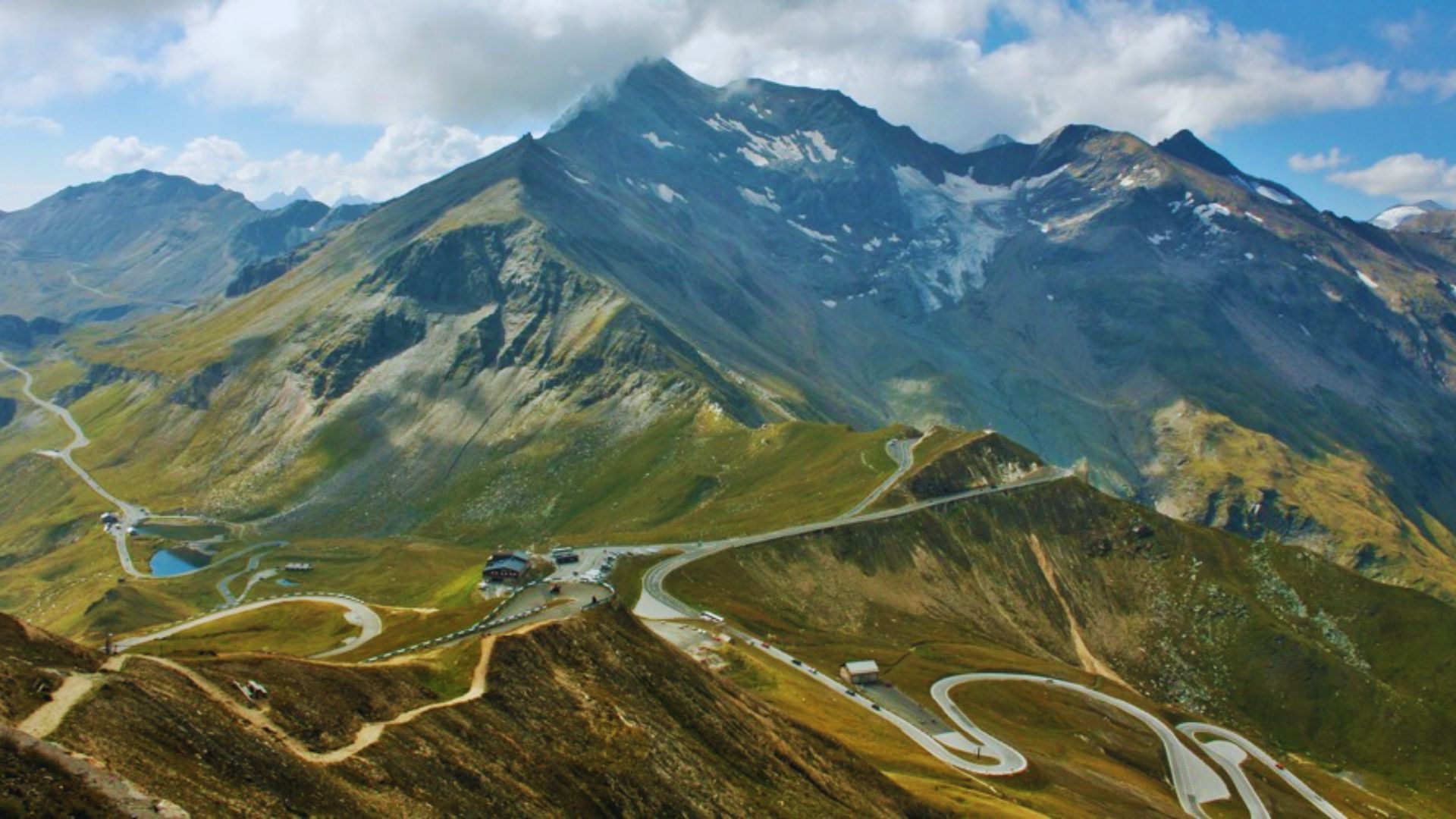 Scenic view of the Swiss Alps, showcasing majestic snow-capped peaks under a clear blue sky.