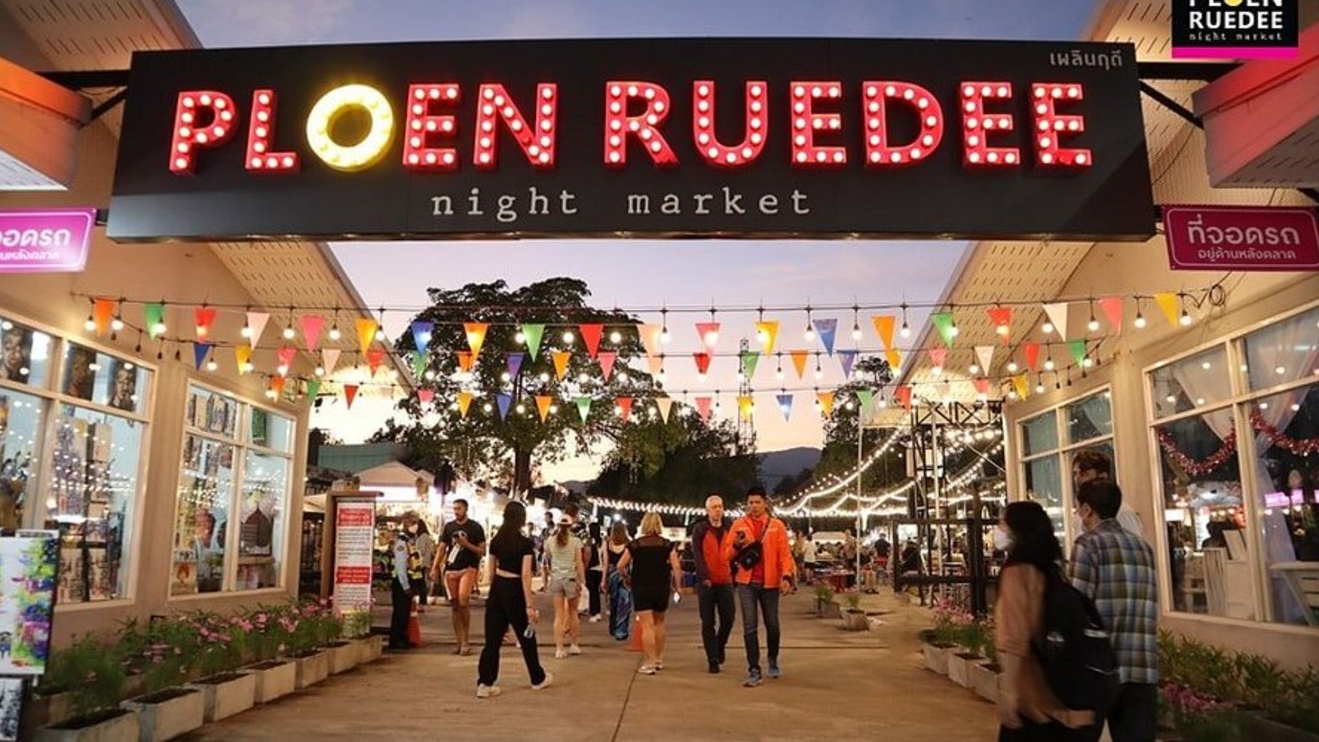 Vibrant scene of Ploen Ruee Night Market, showcasing colorful stalls and bustling crowds under twinkling lights.